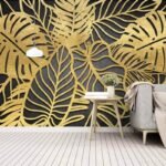 Papier peint – Feuilles de monstera dorées sur fond noir
