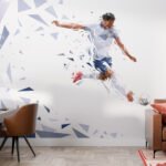 Papier peint – Footballeur en action sur fond géométrique