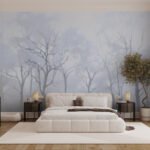 Papier peint – Arbres nus sur fond bleu brumeux